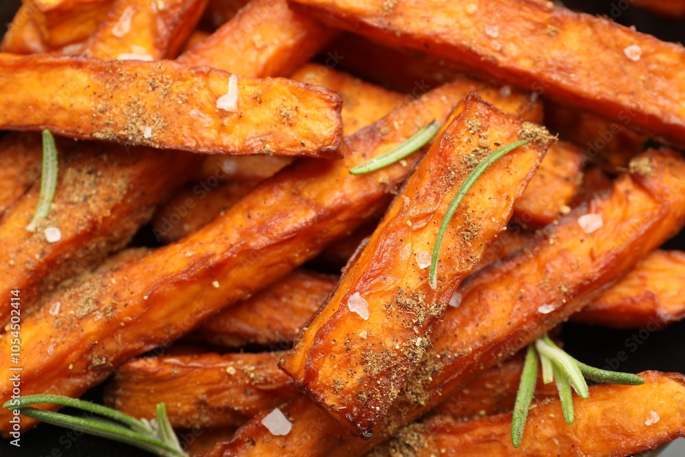 Delicious sweet potato fries with spices as background, closeup Delicious sweet potato fries with spices as background, closeup