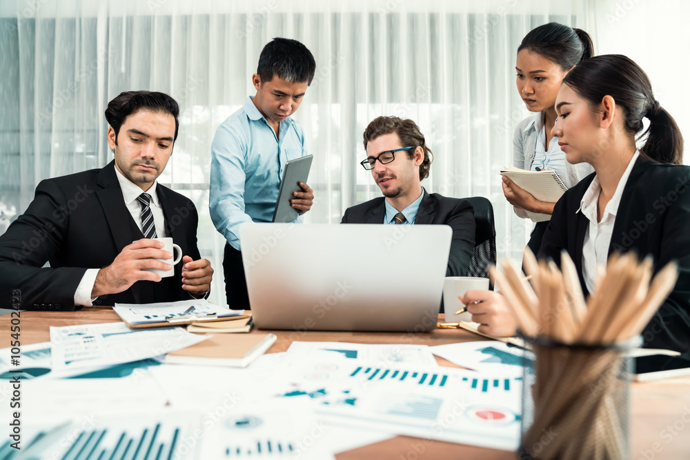 Diverse group of business analyst team analyzing financial data report paper on office table. Chart and graph dashboard by business intelligence analysis for strategic marketing planning Habiliment Diverse group of business analyst team analyzing financial data report paper on office table. Chart and graph dashboard by business intelligence analysis for strategic marketing planning Habiliment