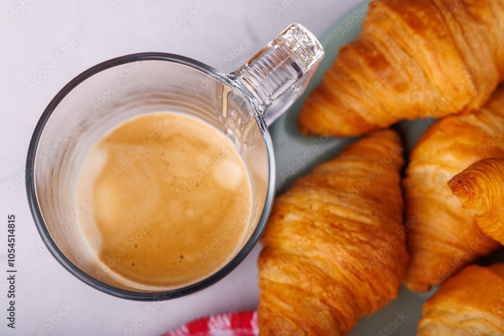 Elegant breakfast layout of fresh croissants and coffee on a light marble table, captured from a bird's-eye view for a stylish feel Elegant breakfast layout of fresh croissants and coffee on a light marble table, captured from a bird's-eye view for a stylish feel