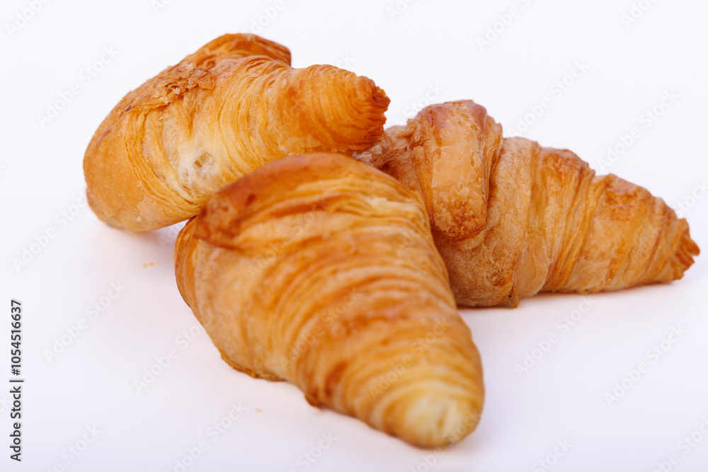 Golden croissants displayed on an endless white background, showcasing detailed texture and shape for a clean, modern presentation Golden croissants displayed on an endless white background, showcasing detailed texture and shape for a clean, modern presentation