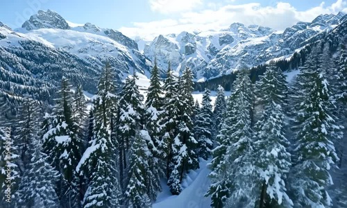 Aerial drone moving forwards in 4k - over beautiful mountains in austria cold snow winter landscape