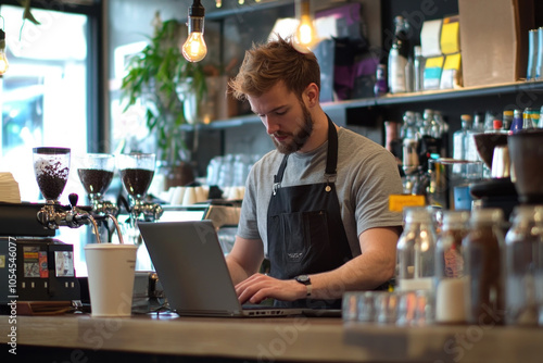 A man typing on a laptop at a bustling coffee shop, surrounded by people chatting and sipping drinks. Sunlight streams through the window onto his focused face.