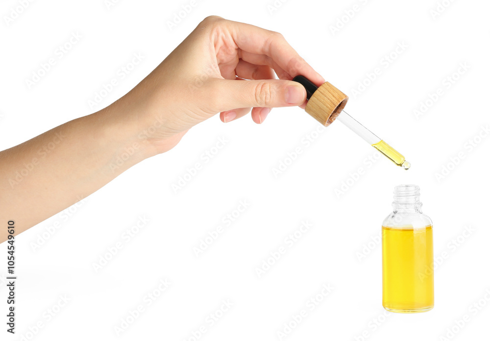 Woman dripping tincture from pipette into bottle on white background, closeup Woman dripping tincture from pipette into bottle on white background, closeup