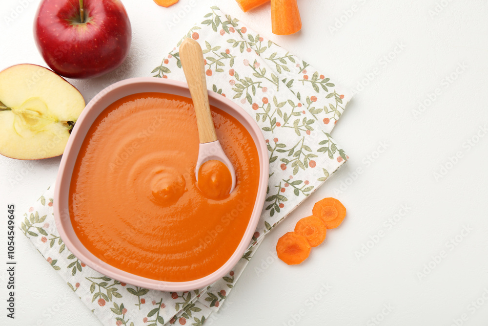 Delicious baby food in bowl and ingredients on white table, flat lay. Space for text Delicious baby food in bowl and ingredients on white table, flat lay. Space for text