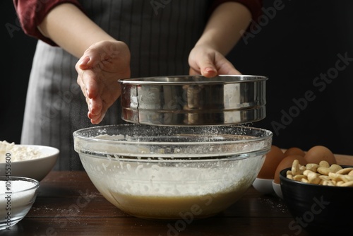 Wallpaper Mural Making cashew cookies. Woman sieving flour into dough at wooden table, closeup Torontodigital.ca