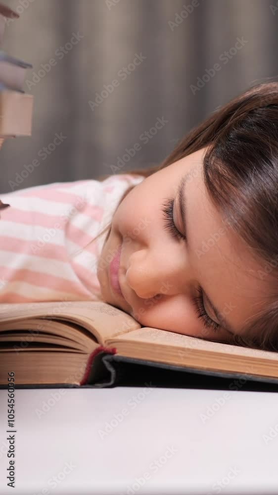 vertical little girl got tired of learning to read and fell asleep on a book vertical little girl got tired of learning to read and fell asleep on a book