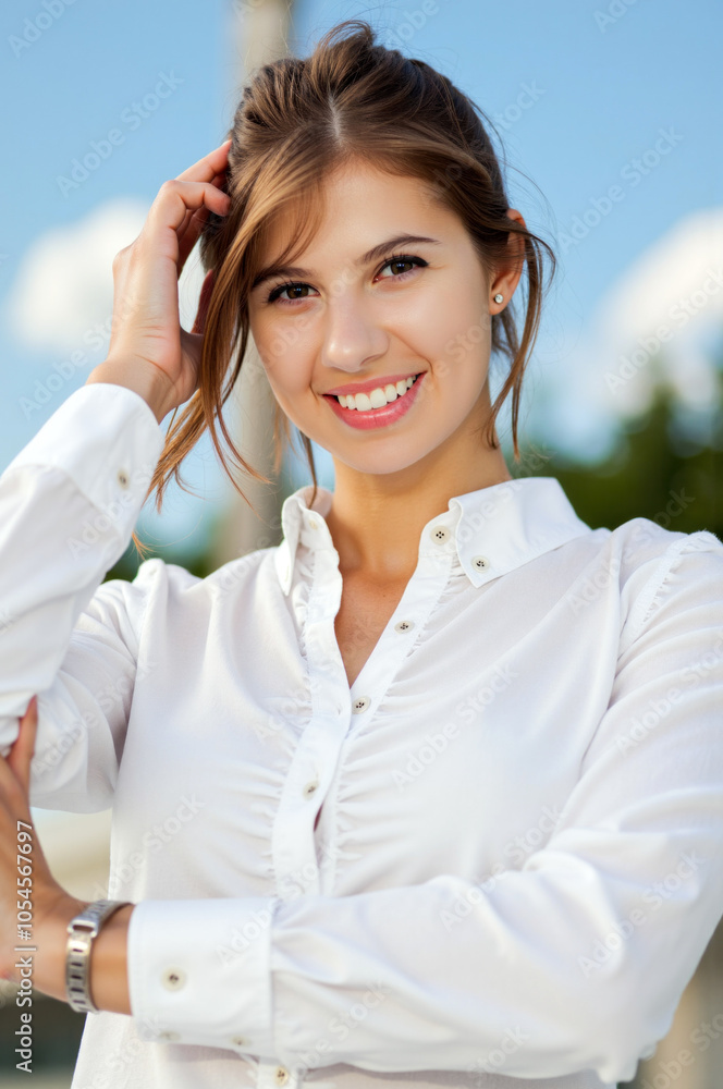 Smiling businesswoman touching hair outdoors in summer Smiling businesswoman touching hair outdoors in summer