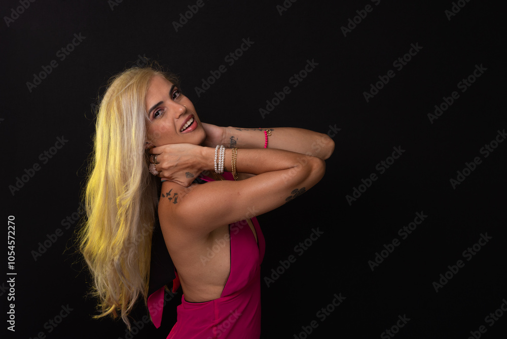 beautiful caucasian woman with blond hair in red dress posing and looking at camera isolated on black background. Studio in the city of Salvador, Bahia. beautiful caucasian woman with blond hair in red dress posing and looking at camera isolated on black background. Studio in the city of Salvador, Bahia.