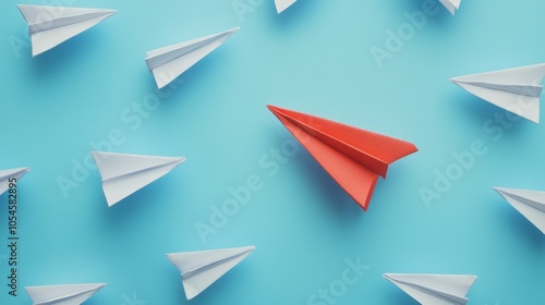 "Red Paper Airplane Leading Among White Paper Airplanes on Blue Background"