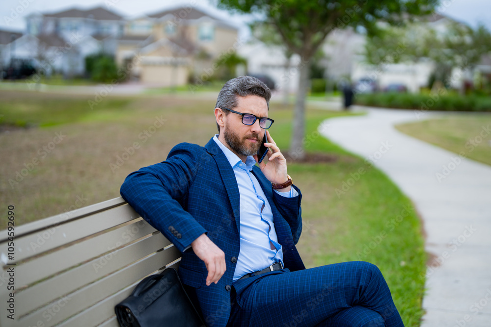 Freelance. Businessman freelancer in suit sitting on bench. Portrait of freelancer on park bench outdoors. Freelancer thinking about business. Freelancer work on laptop on neighborhood. Free business. Freelance. Businessman freelancer in suit sitting on bench. Portrait of freelancer on park bench outdoors. Freelancer thinking about business. Freelancer work on laptop on neighborhood. Free business.