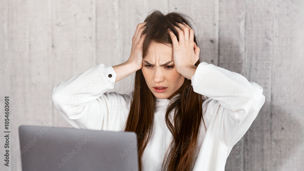 Deadline concept. Freelance woman horrified by amount of work, holds head Deadline concept. Freelance woman horrified by amount of work, holds head
