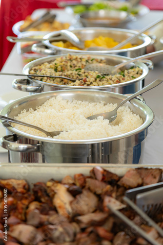 Traditional Brazilian system of serving food in a self-service buffet. Feijão tropeiro, cassava, barbecue, feijoada