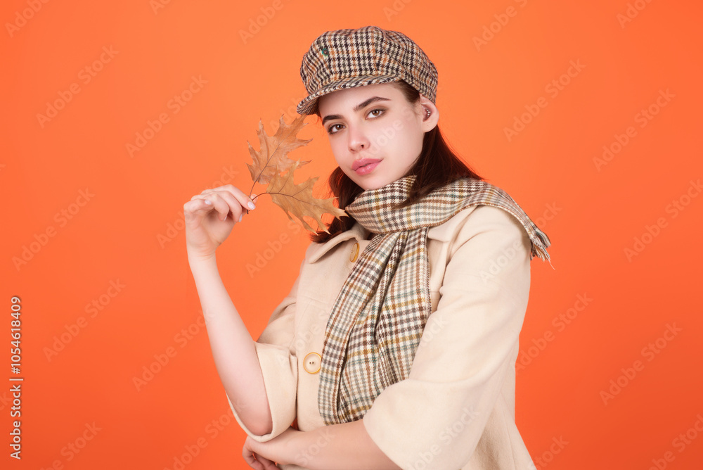 Beautiful woman in autumn clothes hold falling leaves posing in studio. Gorgeous brunette model girl with yellow autumn maple leaf. Autumn woman in studio. Autumnal mood. Beautiful woman in autumn clothes hold falling leaves posing in studio. Gorgeous brunette model girl with yellow autumn maple leaf. Autumn woman in studio. Autumnal mood.