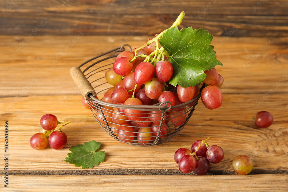 Basket with tasty ripe grapes on wooden background Basket with tasty ripe grapes on wooden background