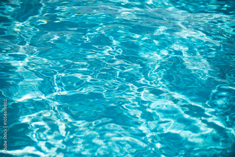 Water background, ripple waves. Blue swiming pool pattern. Sea surface. Water in swimming pool with sun reflection. Banner with copy space. Water background, ripple waves. Blue swiming pool pattern. Sea surface. Water in swimming pool with sun reflection. Banner with copy space.