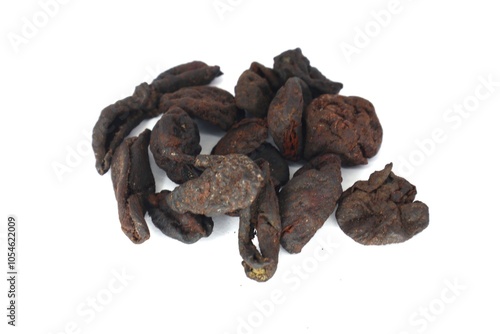 The photo shows a close-up of dried Garcinia xanthochymus (asam kandis) peels. These peels are commonly used in Southeast Asian cuisine, particularly in Indonesian cooking. photo