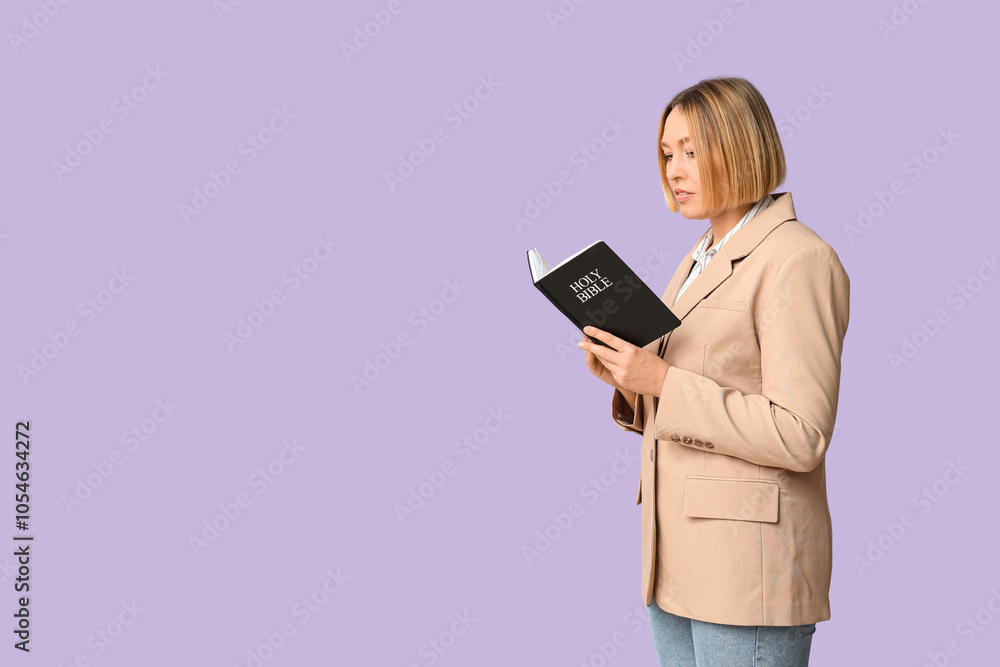 Adult woman reading Holy Bible on lilac background Adult woman reading Holy Bible on lilac background