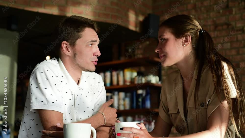 Happy couple in a cafe enjoying their coffee. Man and woman drinking coffee. happy couple having a nice conversation over a cup of coffee in a cozy cafe Happy couple in a cafe enjoying their coffee. Man and woman drinking coffee. happy couple having a nice conversation over a cup of coffee in a cozy cafe