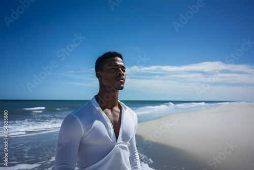 Male Model on the Beach with Blue Sky and Few Clouds in the Background