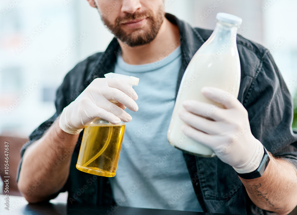 Hands, man and cleaning bottle of milk for health, ocd and virus prevention for safety in home. Spray, person and product disinfection for hygiene, wellness and sanitizing grocery for covid closeup Hands, man and cleaning bottle of milk for health, ocd and virus prevention for safety in home. Spray, person and product disinfection for hygiene, wellness and sanitizing grocery for covid closeup