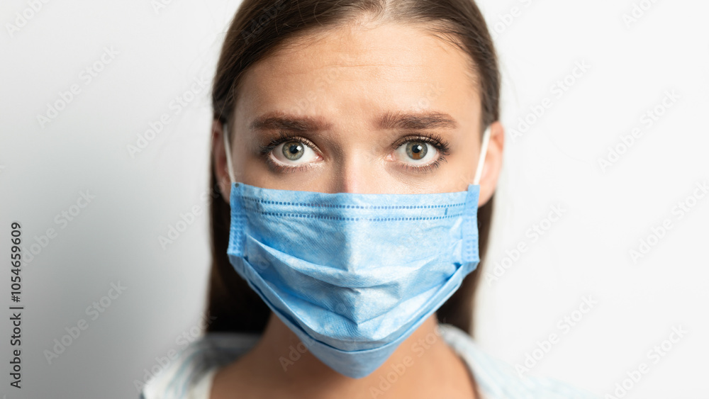 Coronavirus Prevention. Woman In Medical Mask Looking At Camera Posing Over White Studio Background. Empty Space For Text Coronavirus Prevention. Woman In Medical Mask Looking At Camera Posing Over White Studio Background. Empty Space For Text