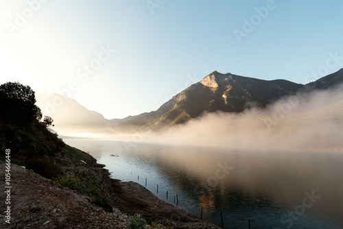 Beautiful sunrise on the lake with majestic mountain in the background