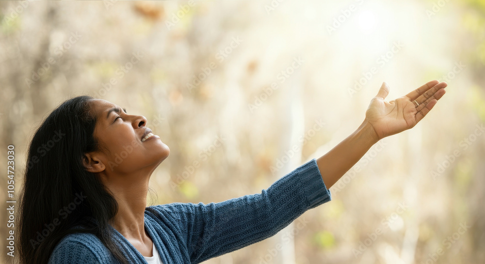 Praising the lord. A woman with her arms raised to the sky in thankfulness and prayer. Themes such as Intercede, Benediction, Supplicate, Atonement, Confession, Comfort, Shelter, Solace, Shield Praising the lord. A woman with her arms raised to the sky in thankfulness and prayer. Themes such as Intercede, Benediction, Supplicate, Atonement, Confession, Comfort, Shelter, Solace, Shield