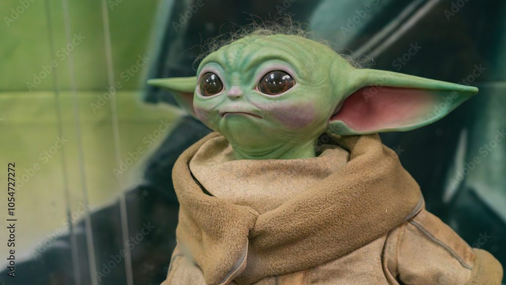 Naklejka premium 8th Comic Con Convention In GUAYAQUIL, ECUADOR - AUG 06, 2023 - Lifelike Grogu (Baby Yoda) figure with detailed features and cute expression, ideal for Star Wars fans and collectors.