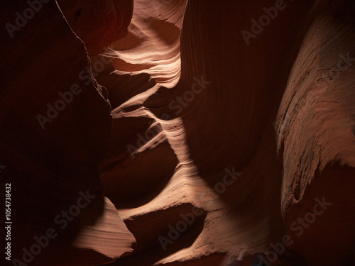 Lower Antelope canyon wall, sun light falling on rippled red sandstone walls photo