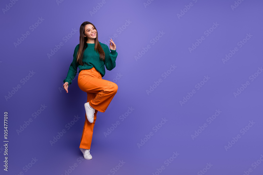 Full size photo of nice young girl dance look empty space isolated on purple color background Full size photo of nice young girl dance look empty space isolated on purple color background