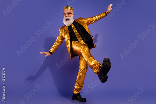 Full body photo of bearded gentleman have fun clubbing wear fashionable golden clothes isolated on violet color background photo