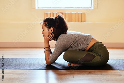 Woman, yoga and stretching with relax, rest and meditation practice on mat in health studio. Wellness, start and warm up with holistic training for balance and calm on floor with pilates equipment