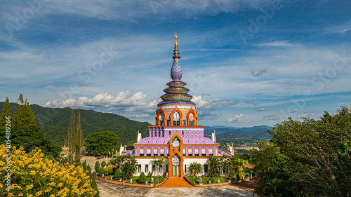 Aerial view of a colourful pagoda overlooking a green valley. pagoda at Wat Thaton on the banks of the Kok River in Chiang Mai Province near the border with Burma..fantastic pagoda of the tribal photo