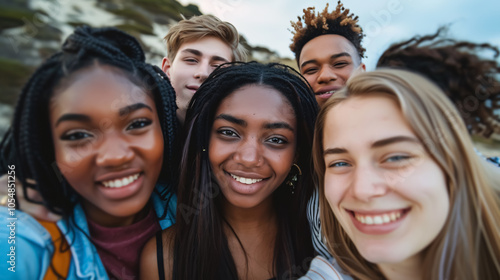 A group of young people from different nationalities taking selfies and smiling, close-up portrait.