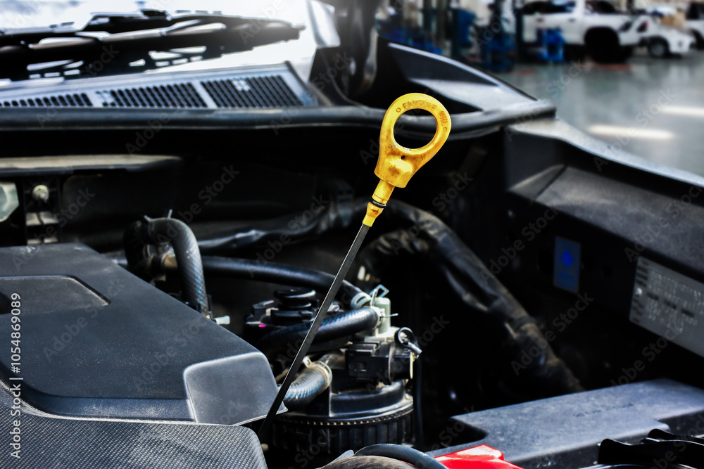 Car engine oil dipstick , car engine oil dipstick is pulled up to check the engine oil level , car maintenance concept