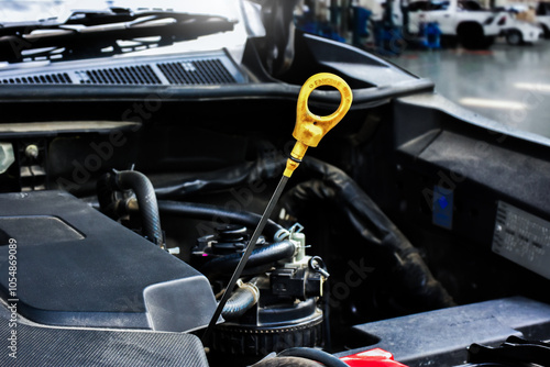 Obraz na płótnie Car engine oil dipstick , car engine oil dipstick is pulled up to check the engine oil level , car maintenance concept w salonie