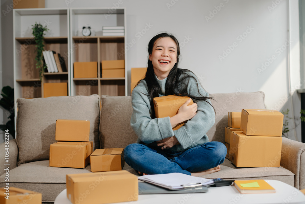 woman using smartphone or tablet taking receive and checking online purchase shopping order to preparing pack product box. . woman using smartphone or tablet taking receive and checking online purchase shopping order to preparing pack product box. .
