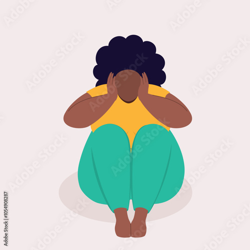 Front View Of One Frustrated Overweight Black Woman Sitting On A Floor And Covering Her Ears With Both Hands.