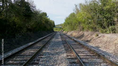 UAV low dolly forward over double railroad tracks.