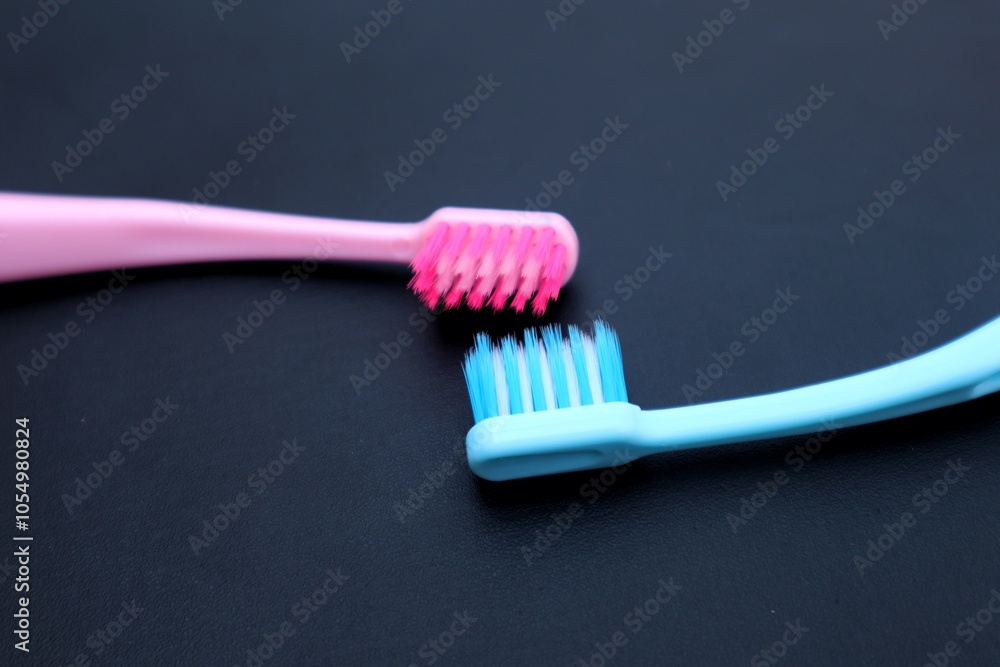 Toothbrush isolated on dark background, close up view. Toothbrush isolated on dark background, close up view.