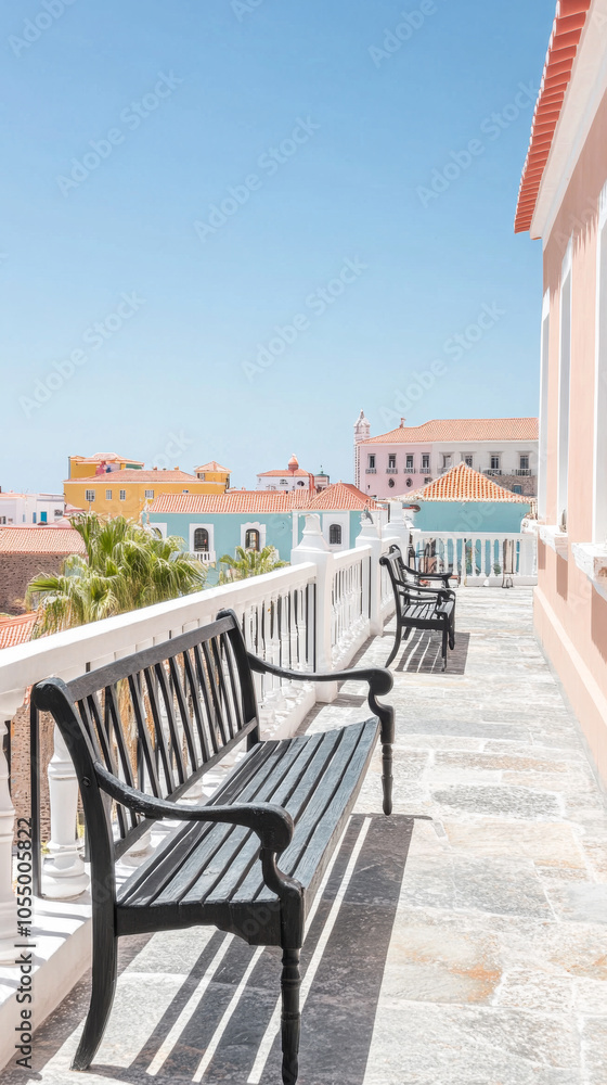 Fototapeta premium Colorful buildings and benches on a sunny terrace in a coastal town