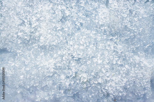 close-up of ice and frost in freezer tray with cold blue tones