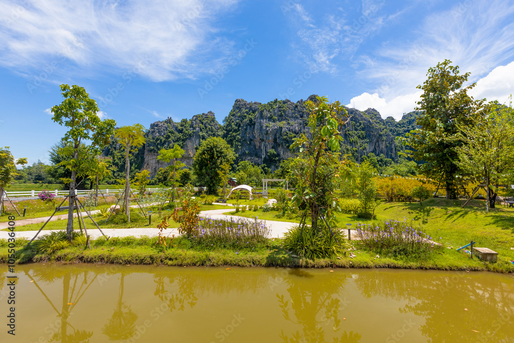 Obraz premium The natural background of the camping ground has chairs to sit and enjoy the natural view. The air is fresh and the atmosphere is surrounded by trees and big mountains.