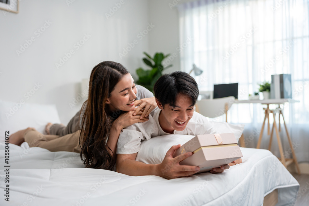 Asian handsome man receive birthday present gift box from girlfriend. Asian handsome man receive birthday present gift box from girlfriend.