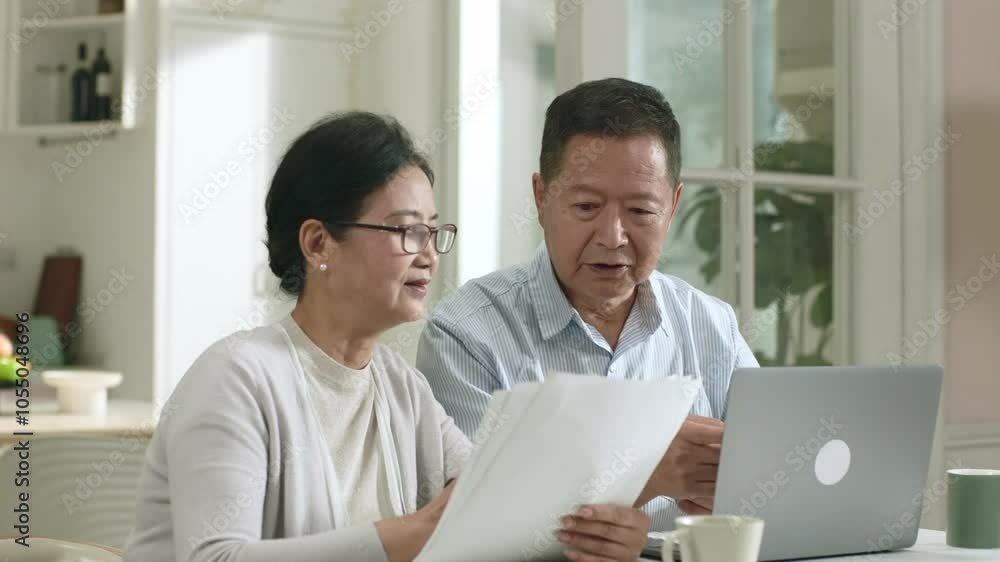 senior asian couple making family financial plan using laptop computer at home senior asian couple making family financial plan using laptop computer at home