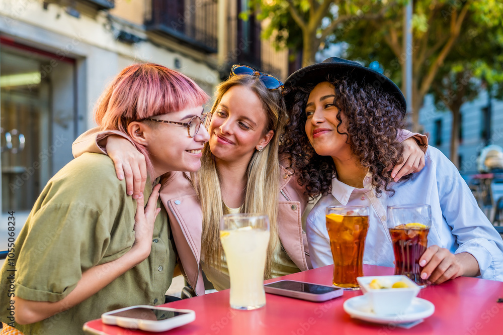 Cute friends embracing while drinking sodas and eat snacks outdoors Cute friends embracing while drinking sodas and eat snacks outdoors