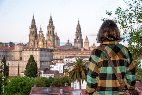 A pilgrim enjoying the sunset over Santiago de Compostela, seen from the famous cathedral viewpoint in the Alameda park, Galicia