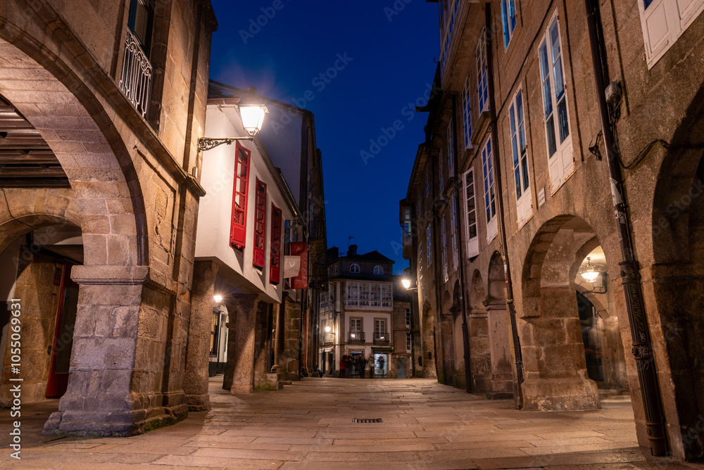 Fototapeta premium Empty little Rua do Vilar street with historic residential houses and picturesque passages in the center of Santiago de Compostela at night