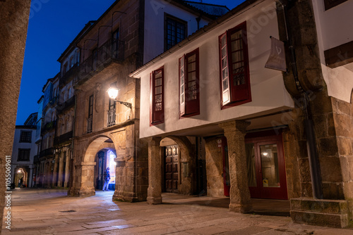 Empty little Rua do Vilar street with historic residential houses and picturesque passages in the center of Santiago de Compostela at night