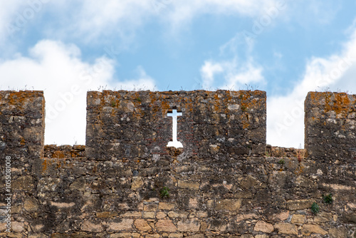 castle battlements with a christian cross at the order of the templar castle in Tomar photo